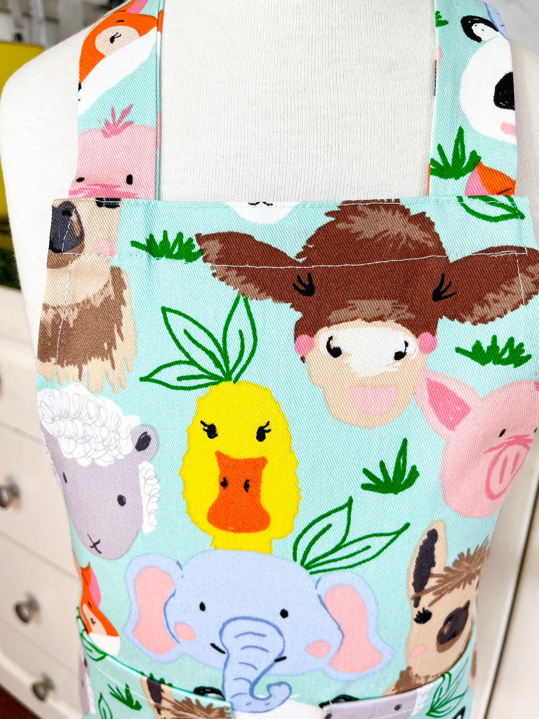 This Toddler's Apron is Covered in All Kinds of Cute Animals