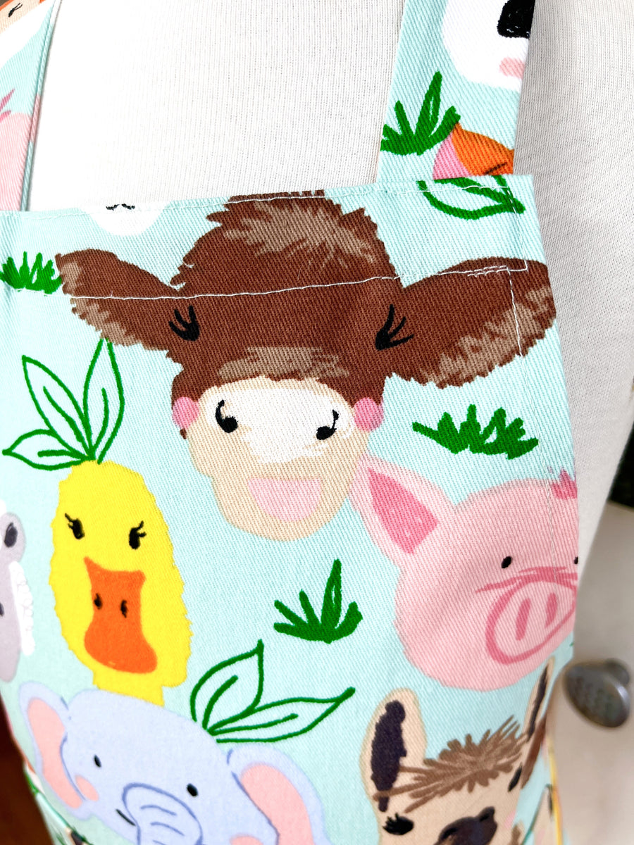 This Toddler's Apron is Covered in All Kinds of Cute Animals