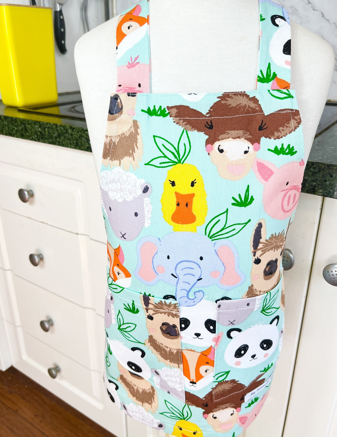 This Toddler's Apron is Covered in All Kinds of Cute Animals