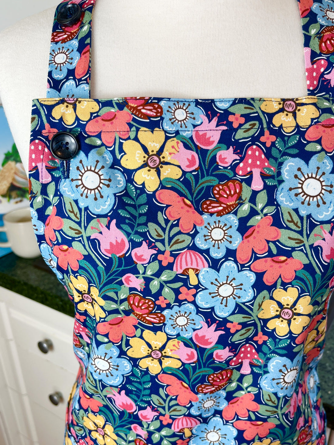 Hunt for the Adorable Butterflies and Mushrooms Within this Lovely Floral Apron