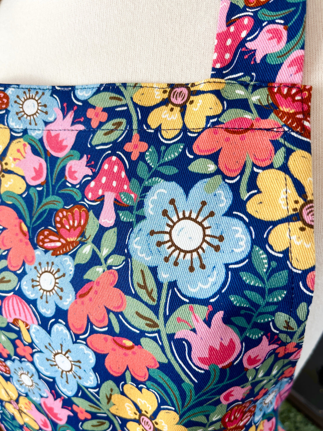 Hunt for the Adorable Butterflies and Mushrooms Within this Lovely Floral Apron