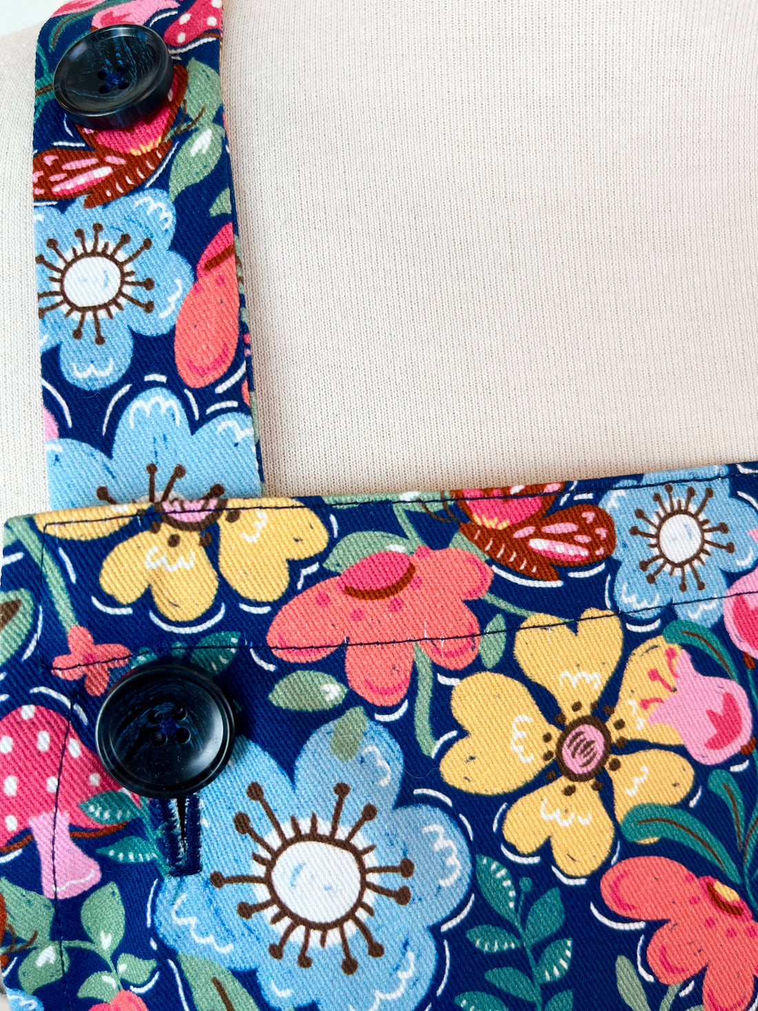 Hunt for the Adorable Butterflies and Mushrooms Within this Lovely Floral Apron