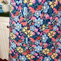 Hunt for the Adorable Butterflies and Mushrooms Within this Lovely Floral Apron