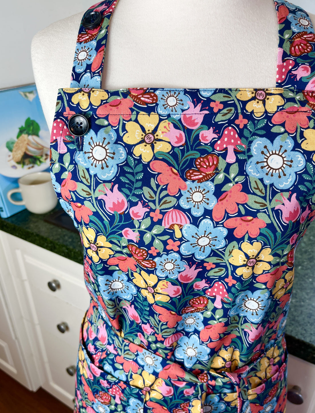Hunt for the Adorable Butterflies and Mushrooms Within this Lovely Floral Apron