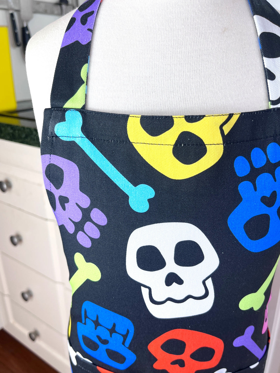 A Bright and Kooky Kid's Apron Covered in Bones