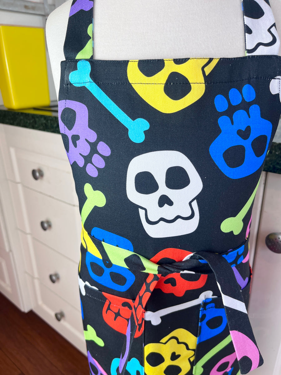 A Bright and Kooky Kid's Apron Covered in Bones