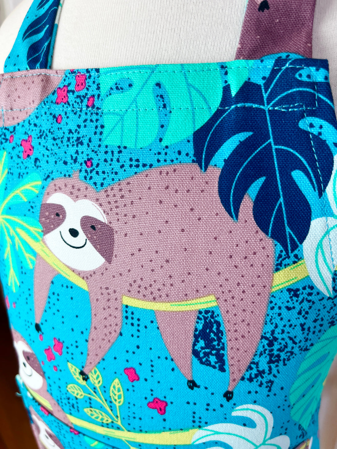 This Toddler's Apron is Covered in the Cutest Sloths