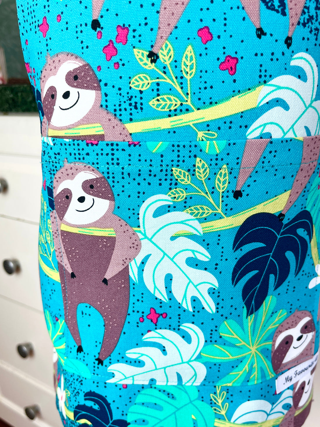 This Toddler's Apron is Covered in the Cutest Sloths